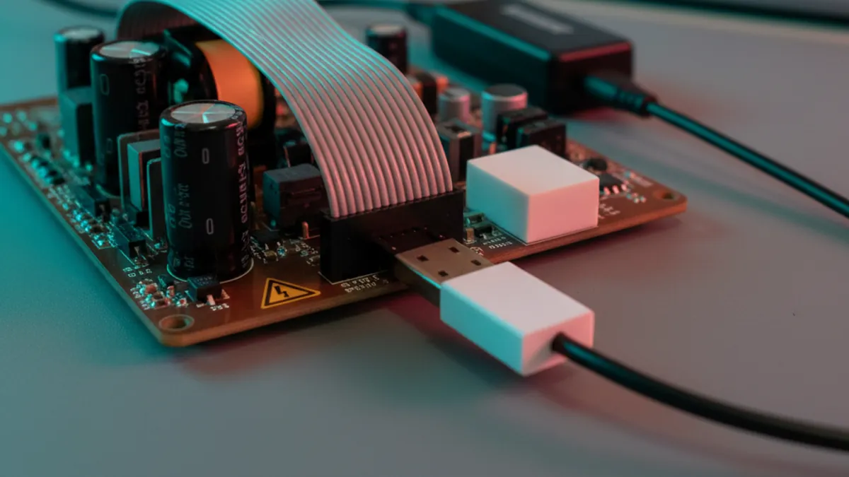 Isolated SEGGER J-Link debug probe connected to a high-voltage motor-control inverter board on an Indian embedded engineering bench
