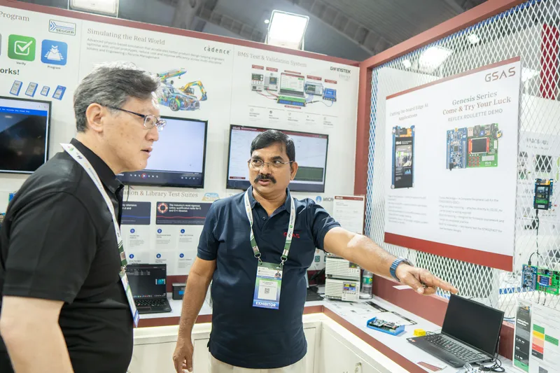 A GSAS engineer talks a visitor through the demo wall at electronica India 2026, Bengaluru
